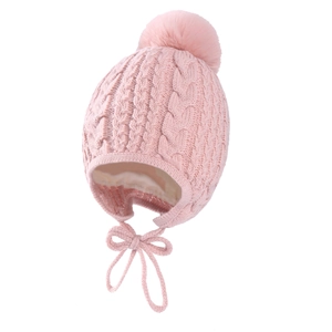 Pink cable-knit baby winter hat with large pompom, ear flaps and cozy lining details