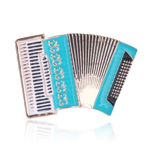 Detailed close-up of teal and white enamel accordion brooch with golden metal base