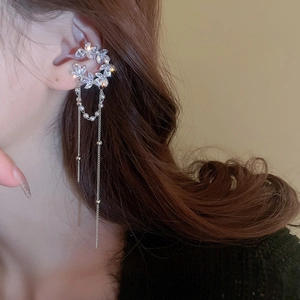 Detailed view of silver flower ear bone clip with long tassels and zircon accents