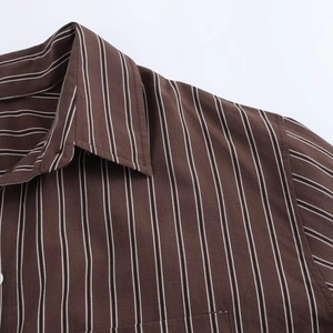 Detailed view of brown striped shirt collar and shoulder with high-quality fabric texture
