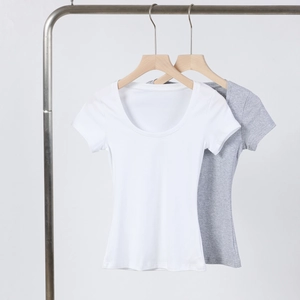 Detail view of white and gray U-neck slim fit t-shirts hanging on wooden hangers