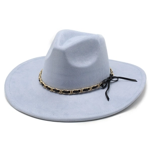 Detail of light blue faux suede fedora featuring a gold chain and black ribbon bow