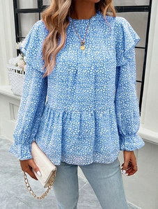 Detail of blue floral chiffon blouse showing ruffled shoulders and layered doll-style hem