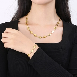 Titanium steel necklace and bracelet set with hollow smile face charms in gold finish