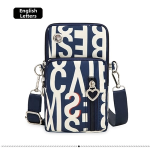 Detail view of Oxford cloth crossbody phone bag with three zippered layers and heart pullers