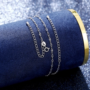 Detail of silver chain necklace with adjustable spring clasp on blue jewelry display stand