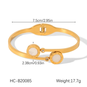 Detailed view of bicolor stainless steel star cuff with Roman numerals and inlaid shell