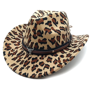 Detail of leopard print cowboy hat featuring a leather band and silver bull skull charm