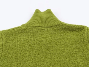 Detail of green rib-knit mock neck sweater featuring rich waffle texture and stitching