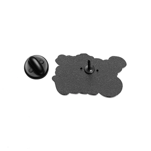 Detail view of the black metal badge back featuring a matte texture and rubber clutch