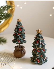 Detailed view of mini Christmas tree tabletop ornaments with festive fabric bag bases