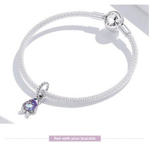 Detail of silver mesh bracelet with Forever Love clasp and purple mermaid fish charm