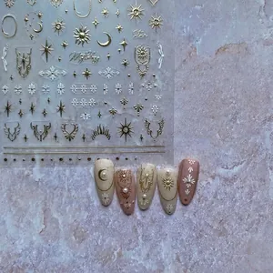 5D embossed nail stickers featuring gold celestial sun moon stars and sacred geometry patterns