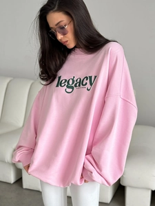 Pink oversized cotton sweatshirt with green legacy lettering for women in street style