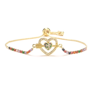 Adjustable gold heart arrow bracelet with colorful zircon stones on white background