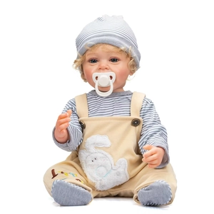 Lifelike 55cm Yannik reborn baby doll with blonde curls and beige overalls on white background