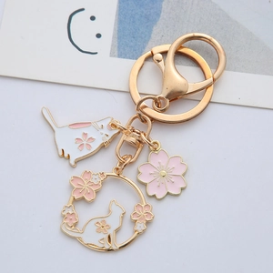 Japanese style cherry blossom cat keychain with pink enamel charms on gold lobster clasp