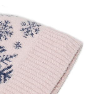 Close-up of pink knit hat featuring navy snowflake pattern and soft faux mink texture
