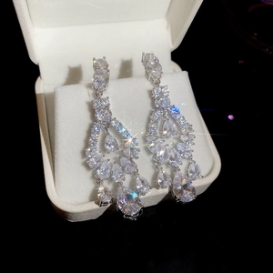 Macro shot of silver-tone zircon butterfly drop earrings with pear-cut stones in a box