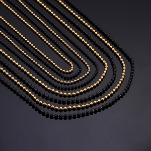 Polished gold and black beaded stainless steel layered necklaces in U-shape arrangement