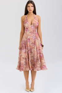 Detail of a pink paisley print backless maxi dress with a halter neck and flowy hem