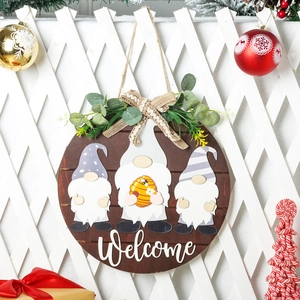 Detail of wooden Welcome door sign with gnome design and festive holiday decorations