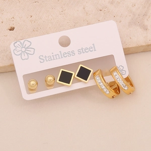 Three-piece stainless steel earring set with gold spheres, black squares, and crystal hoops