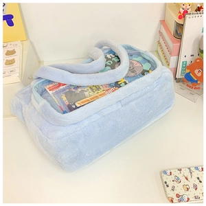 Macro view of light blue plush handbag with clear PVC window for displaying anime accessories
