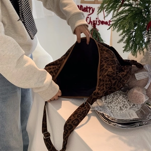 Close-up of leopard print shoulder bag interior with festive Christmas decorations