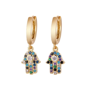 Macro detail of gold Hamsa Hand earrings with colorful cubic zirconia pavé stones