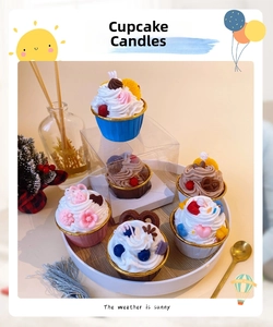 Detail of assorted cupcake scented soy candles with realistic strawberry and chocolate toppings