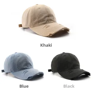 Detailed view of distressed baseball caps in khaki, blue, and black washed cotton canvas