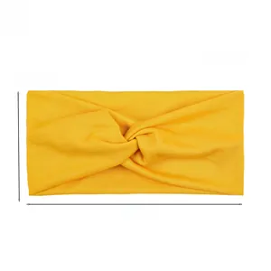 Detail showing dimensions of the yellow knotted yoga headband with 10cm height and 22cm width