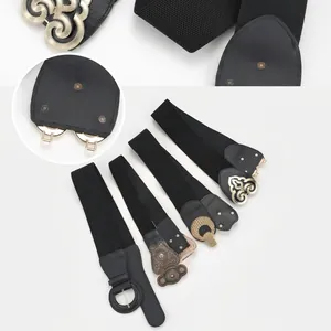 Detail showing four vintage metal buckles and elastic fabric on wide black waist belts