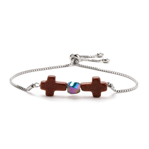Detail of adjustable silver chain with brown cross stones and iridescent central bead