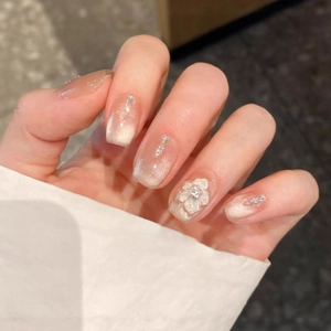 Cat eye gradient press-on nails with 3D white flowers and sparkling rhinestone accents