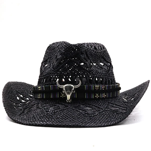 Detail of black straw cowboy hat with镂空weave and ethnic band featuring a silver bull skull
