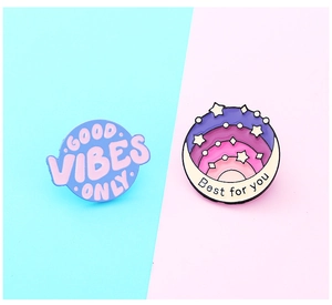 Close-up of two round enamel pins with Good Vibes Only and Best for you text