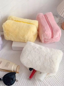 Sweet macaron-colored plush makeup bags in pink, yellow, and white for storage