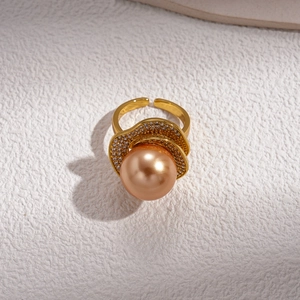 Macro shot of a gold wavy ring with champagne pearl and sparkling pavé crystals