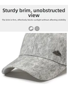 Macro shot of grey baseball cap with metal mountain badge and precise stitching details