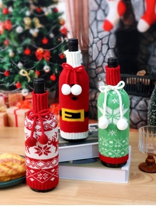 Three festive knitted Christmas wine bottle covers with reindeer and Santa designs