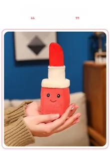 Detailed plush lipstick keychain with a cute smiley face held in hand, soft velvet texture