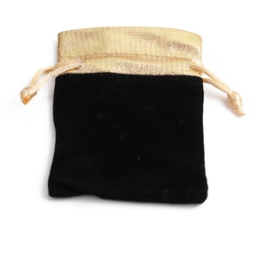 Black velvet drawstring jewelry pouch with a gold silk satin trim for gift packaging