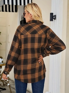 Detail shot of classic plaid shirt back featuring clean tailoring and buttoned cuffs