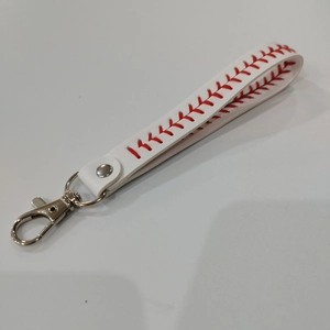Detail view of baseball leather wristlet keychain with red stitching and silver clasp