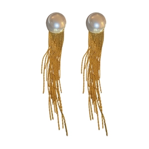 Elegant gold tassel earrings with round white pearls and delicate metallic chain fringe