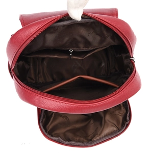 Red soft faux leather backpack with large capacity showing interior pockets and lining