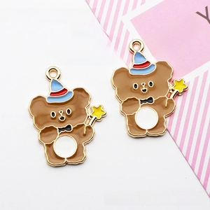 Close-up of two cute alloy bear charms with magic wands for DIY jewelry making