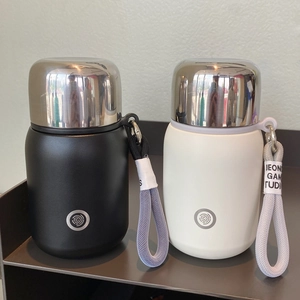 Detail view of mini matte stainless steel vacuum flasks with portable woven lanyards